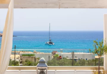 Beautiful sea view from Marcos Beach Hotel in Ios, Greece, with a sailing boat anchored offshore