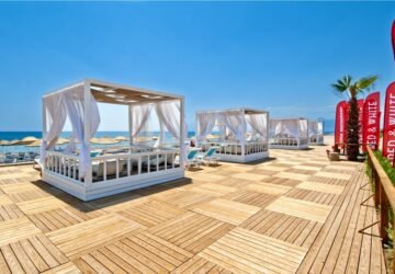 Beachfront relaxation area with cabanas at Holiday Inn Antalya Lara Hotel in Antalya, Turkey